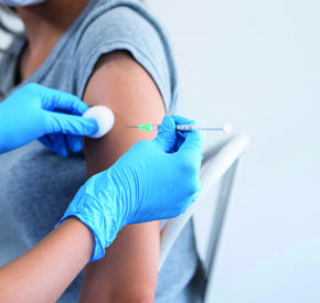 Hand of a doctor giving a syringe vaccine
