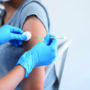 Hand of a doctor giving a syringe vaccine