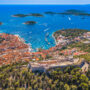 The old town of Hvar, Croatia, basking in the sunlight with the bright blue waters of the Adriatic in the background