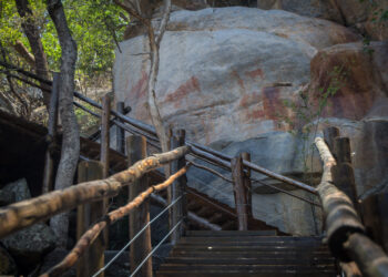Paintings on a rock at the end of a wooden staircase in Botswana