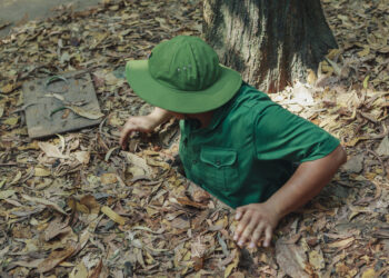 A man climbing out of the Viet Cong tunnels near Ho Chi Minh City