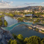Panoramic aerial view of downtown Tbilisi, Georgia. In the foreground is the Peace Bridge over the Mtkvari River