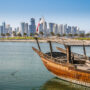 Traditional dhow boat in front of Doha's West Bay skyline