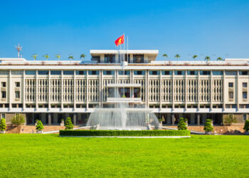 Exterior view of the Independence Palace with a grand water fountain in front