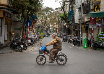An elderly Vietnamese man rides his bicycle in Hang Bac, in the Old Quarter of Hanoi